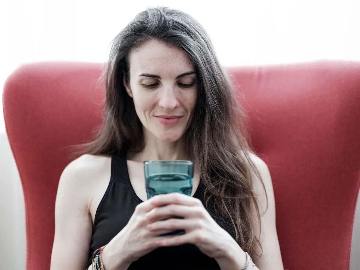 Woman relaxing with a drink — the truth about the cortisol detox trend